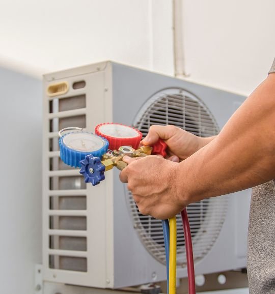 A man grips a hose and air conditioner, showcasing heating and air conditioning repair services in Chicago, IL.