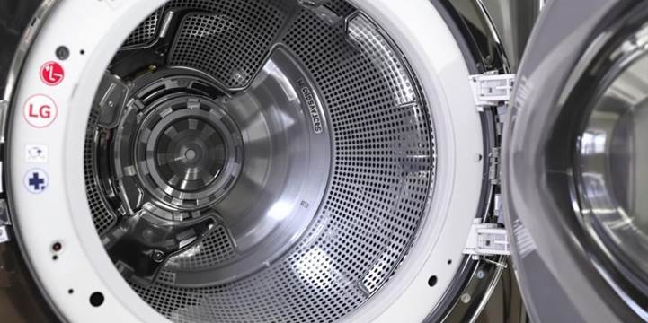  A close-up view of an open washing machine door, showcasing the interior and its components clearly.